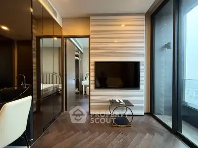 Modern living room with sleek design and city view, featuring a wall-mounted TV and stylish flooring.