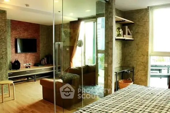 Modern living room with glass partition and stylish decor in urban apartment