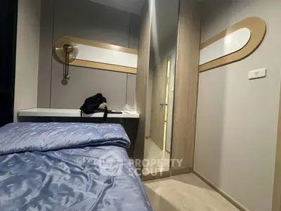 Modern bedroom with stylish decor and cozy bedding in a contemporary apartment.