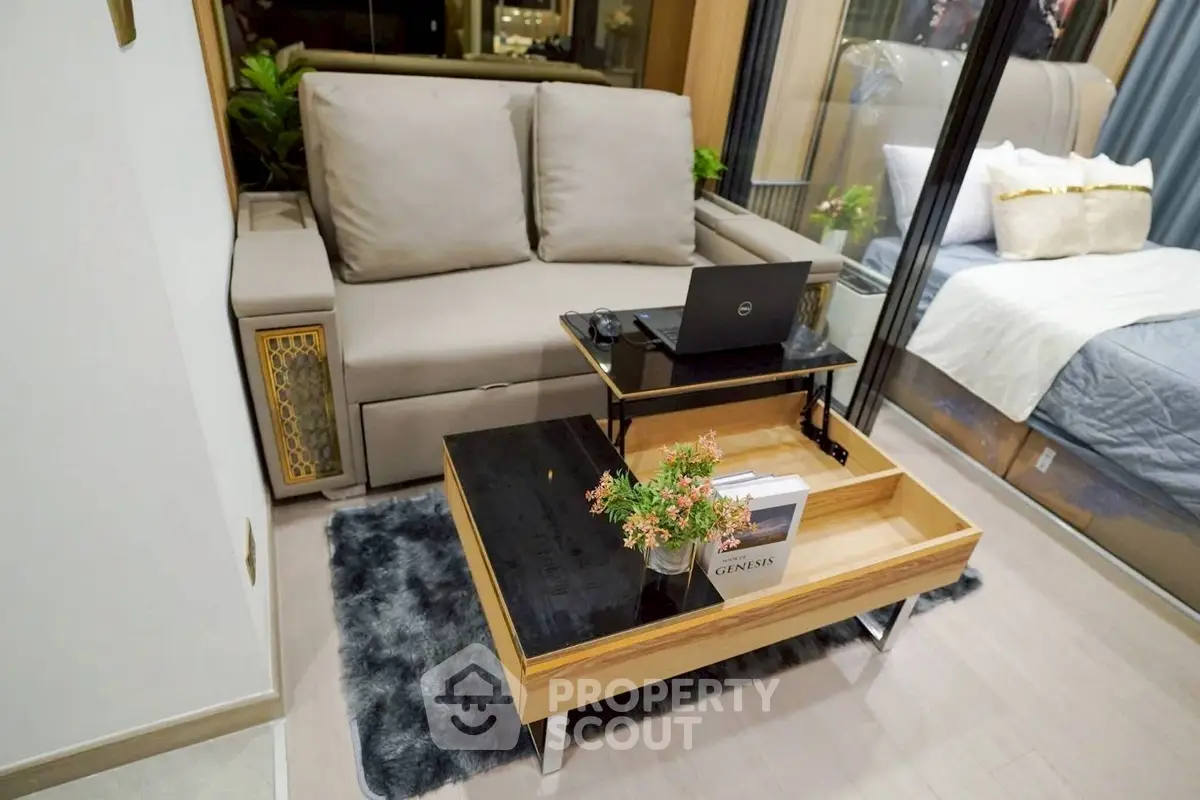 Modern living room with cozy sofa and stylish coffee table in a chic apartment.