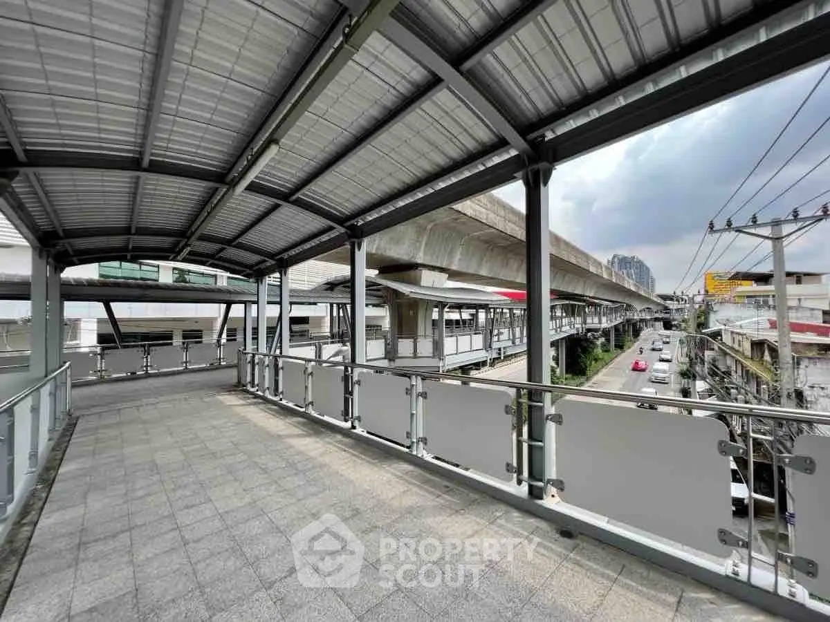 Spacious urban skywalk with modern design and city view.