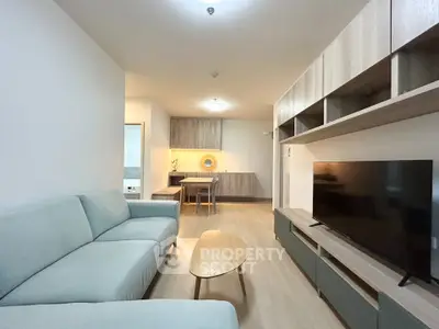 Modern living room with stylish furniture and entertainment center in a cozy apartment.