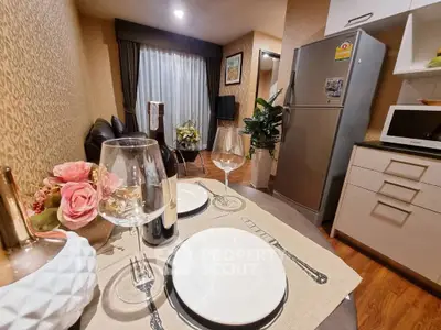 Cozy dining area with elegant table setting and modern kitchen appliances.