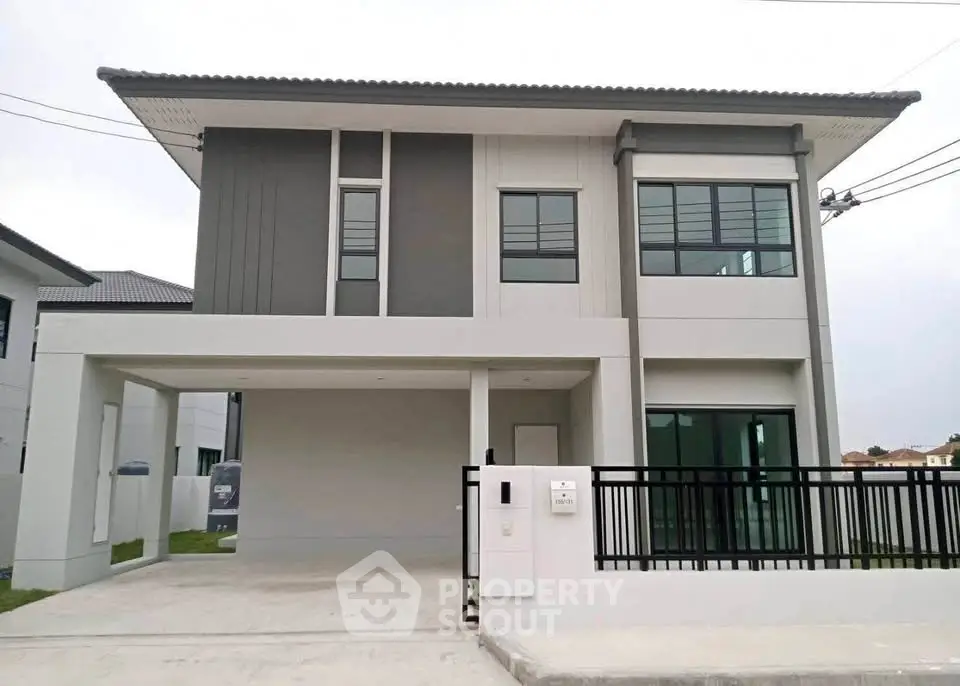 Modern two-story house with sleek design and spacious driveway