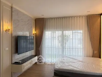 Spacious bedroom with modern decor and large window for natural light