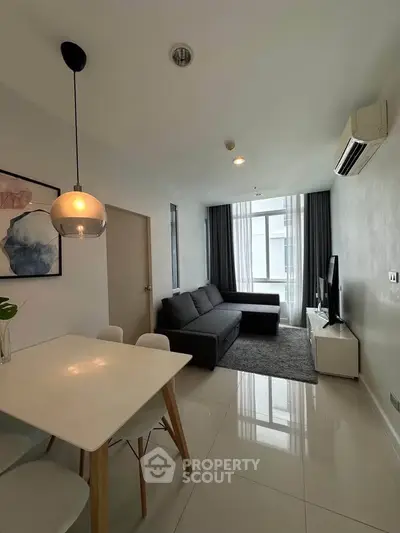 Modern living room with sleek furniture and natural light, perfect for urban living.