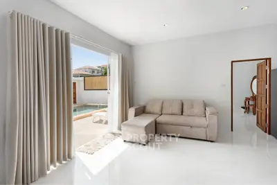 Bright living room with pool view and cozy sofa in modern home