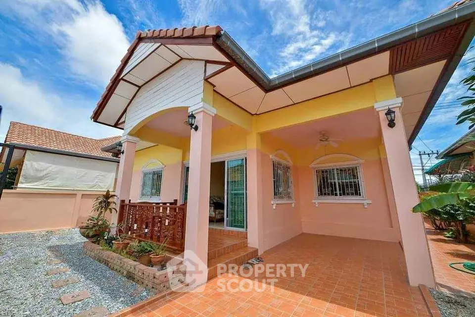 Charming single-story home with tiled patio and vibrant exterior