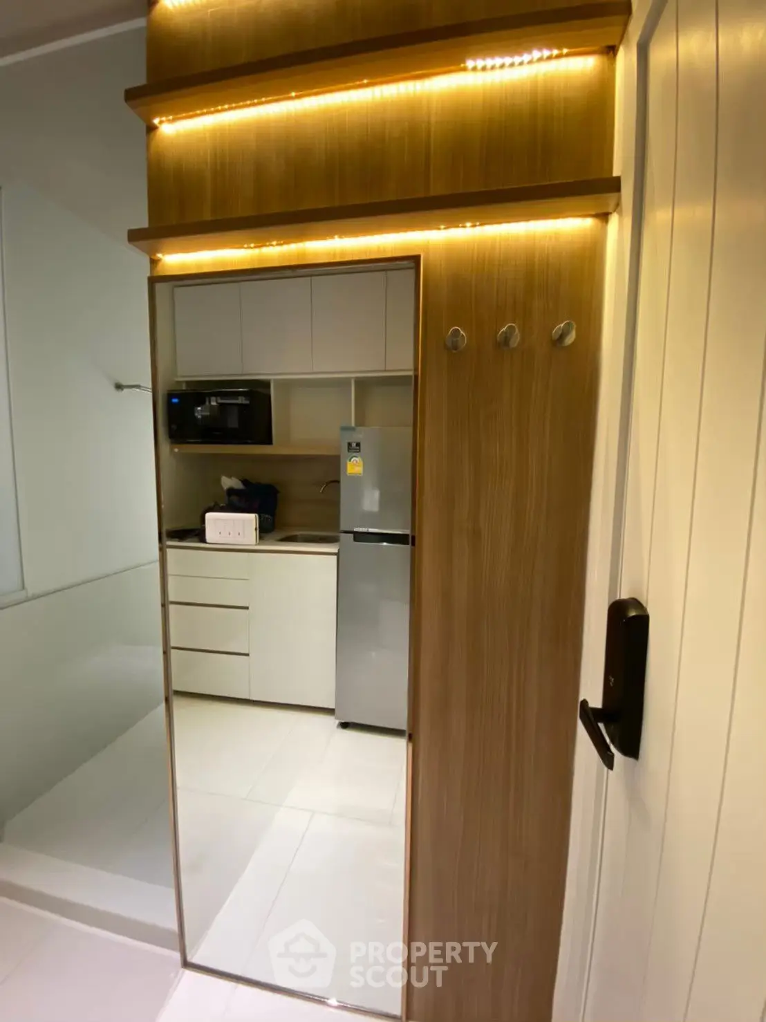 Modern kitchen with sleek cabinetry and built-in appliances in a compact space.