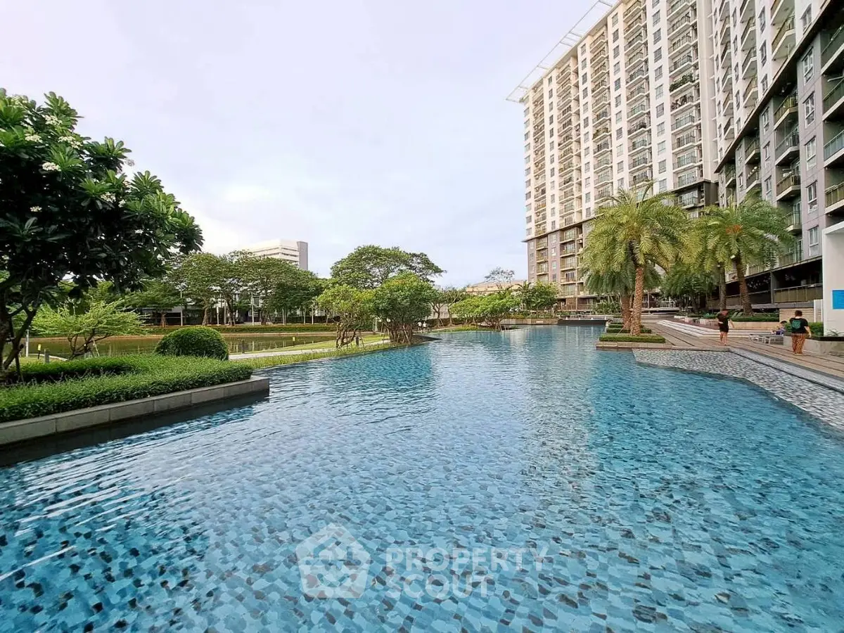 Luxurious residential complex with stunning pool and lush greenery
