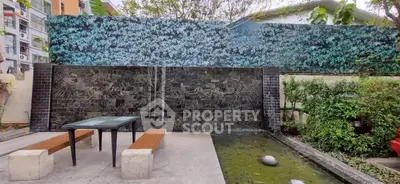 Modern outdoor garden area with water feature and seating, perfect for relaxation and gatherings.