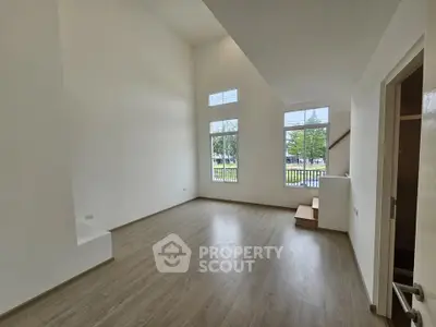 Spacious modern living room with high ceilings and large windows