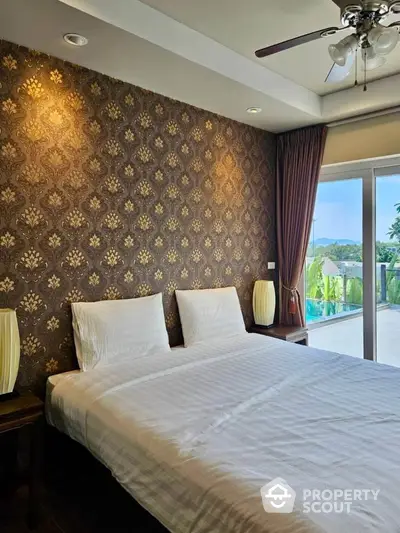 Luxurious bedroom with elegant wallpaper and balcony view