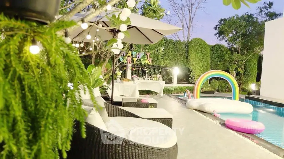 Luxurious poolside area with stylish seating and vibrant decor, perfect for relaxation and entertainment.
