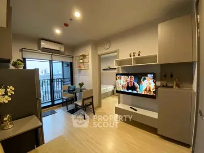 Modern living room with balcony view, stylish furniture, and wall-mounted TV in a cozy apartment.