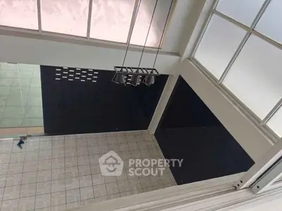 Spacious modern interior with high ceilings and large windows, perfect for natural light.