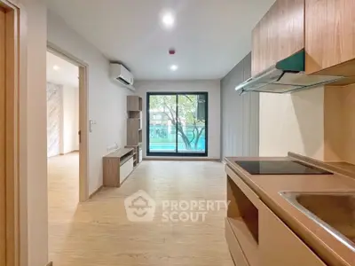 Modern open-plan living room with kitchen and large window view
