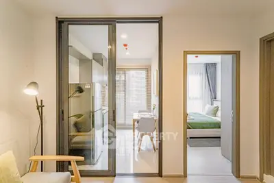 Modern apartment interior with open kitchen and cozy bedroom, featuring sleek design and natural light.