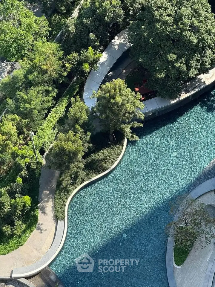 Stunning aerial view of a serene garden with winding water feature and lush greenery.