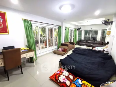 Spacious living room with modern decor and large windows for natural light.