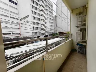Urban balcony with city view and utility area, ideal for compact living spaces.
