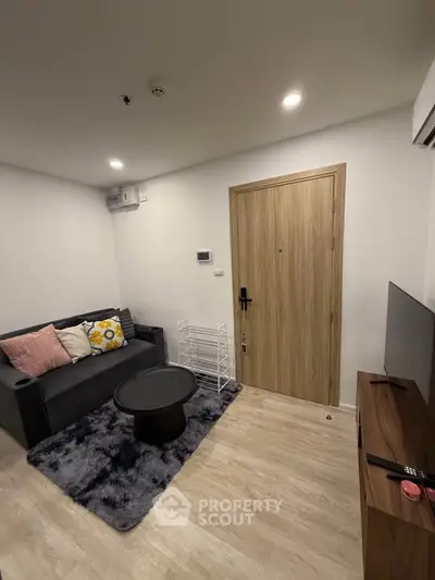 Cozy modern living room with stylish decor and comfortable seating in a contemporary apartment.