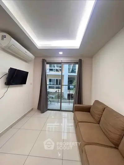 Modern living room with sleek design, featuring a cozy sofa, wall-mounted TV, and large window with balcony view.
