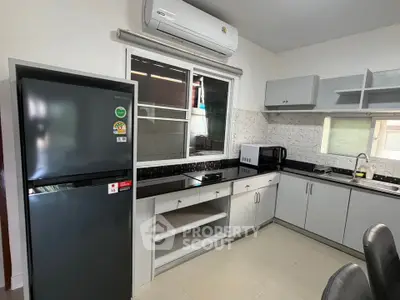 Modern kitchen with sleek appliances and ample storage space.