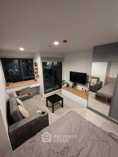 Modern studio apartment with cozy living area and city view