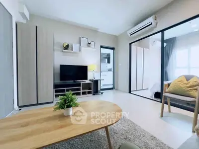 Modern living room with open layout and stylish decor, featuring a cozy seating area and natural light.