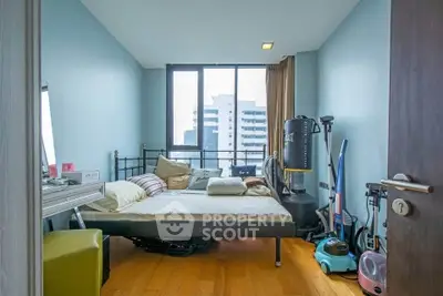 Modern bedroom with city view and exercise equipment, perfect for urban living.