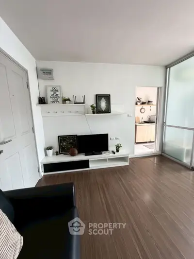 Modern living room with sleek decor and open kitchen view