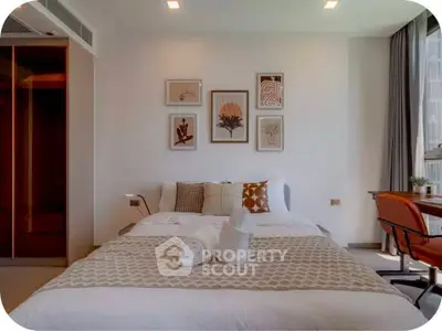 Modern bedroom with stylish decor and natural light, featuring a cozy bed and elegant wall art.