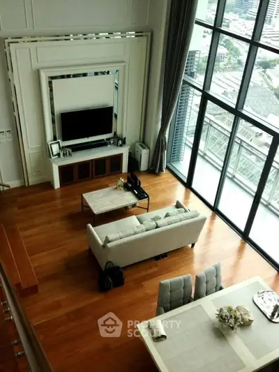 Luxurious high-rise living room with floor-to-ceiling windows and stunning city view.