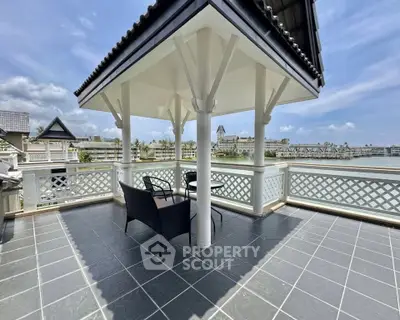 Stunning waterfront balcony with elegant gazebo and breathtaking views, perfect for relaxation and outdoor enjoyment.