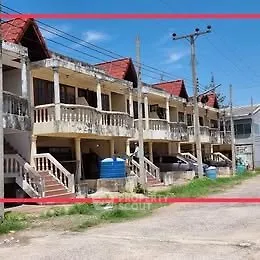 Charming row of townhouses with red roofs and spacious balconies, perfect for family living.