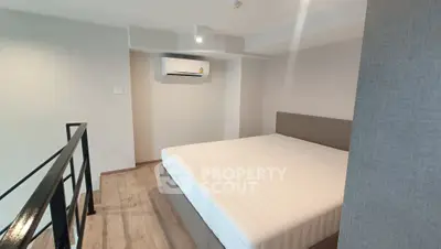 Modern bedroom with minimalist design and air conditioning in a stylish apartment.