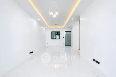 Spacious modern living room with elegant lighting and glossy white flooring
