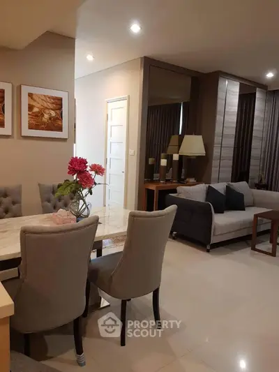 Elegant open-plan living and dining area with modern decor and cozy seating.