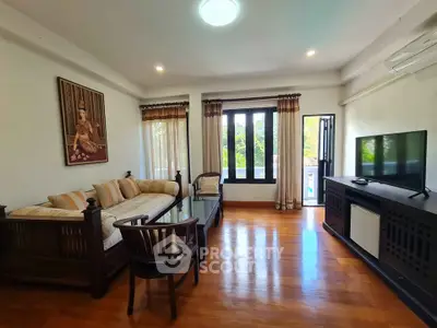 Spacious living room with elegant decor and large windows offering natural light