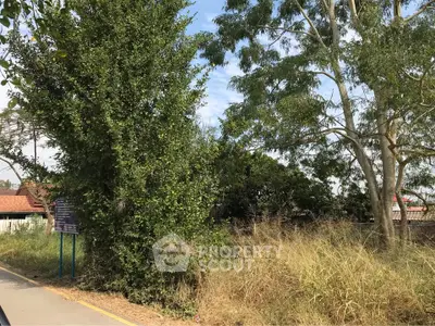 Lush greenery surrounds a potential real estate plot, offering serene natural views.