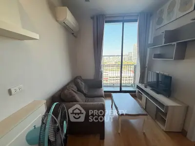 Cozy living room with city view, featuring modern sofa and entertainment center.