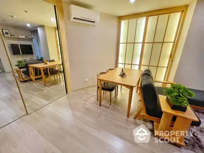 Modern dining area with wooden furniture and ambient lighting in a stylish apartment.