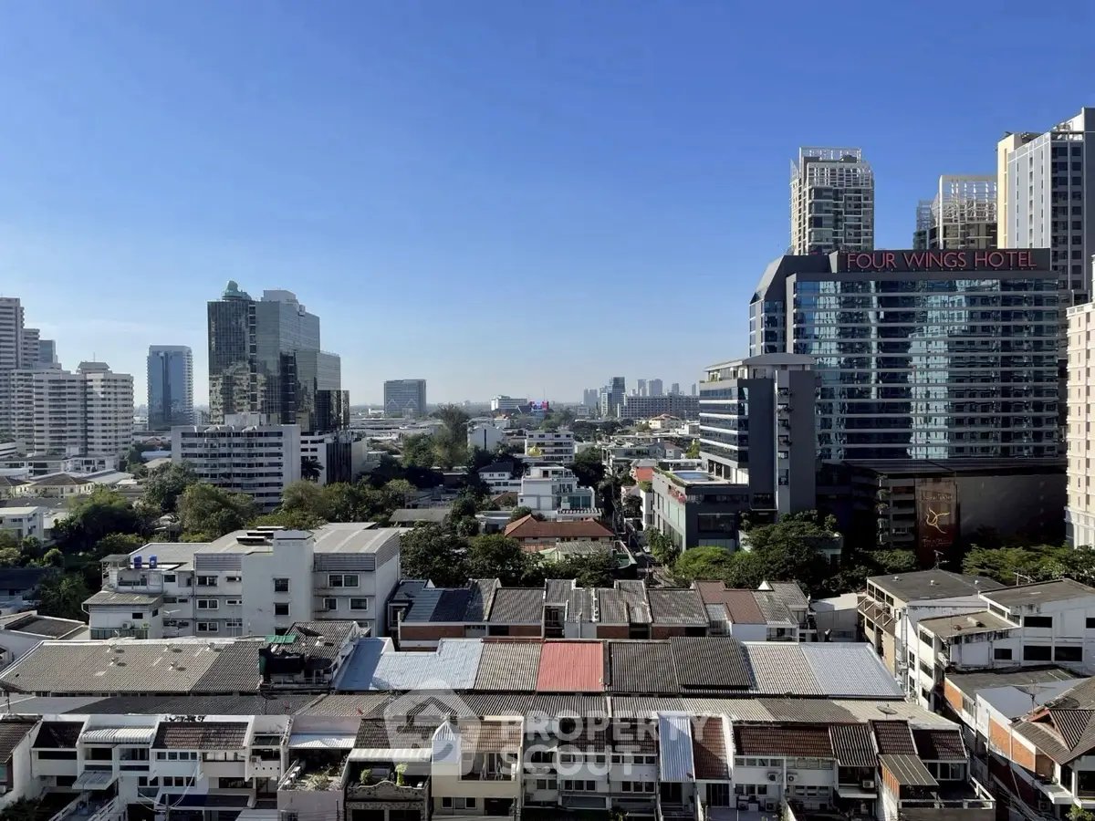 Stunning cityscape view from a high-rise building showcasing urban skyline and vibrant architecture.