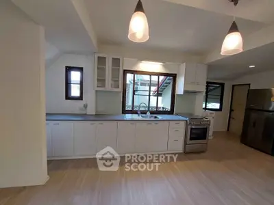 Spacious modern kitchen with sleek cabinetry and stainless steel appliances