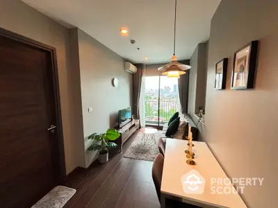 Modern living room with balcony view, stylish decor, and natural light in urban apartment.