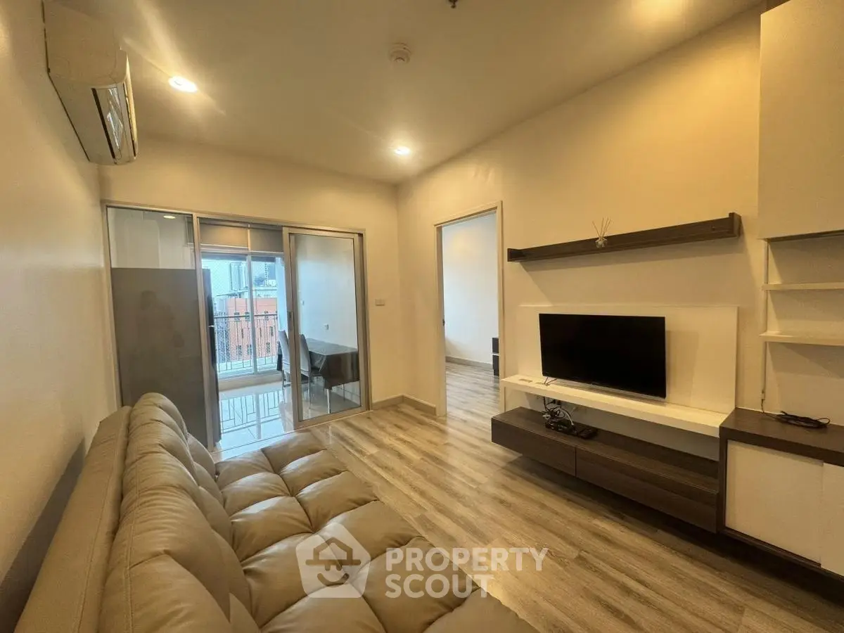 Modern living room with sleek design and balcony access in urban apartment