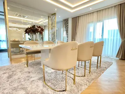 Luxurious dining room with elegant chairs and modern decor, perfect for sophisticated gatherings.