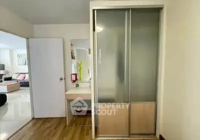 Modern apartment interior with sliding closet doors and wooden flooring