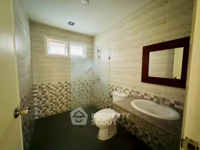 Modern bathroom with dual sinks and glass shower enclosure